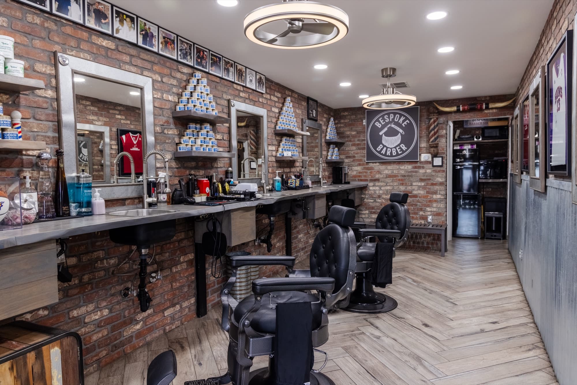 Bespoke Barber shop interior in Arcadia, Phoenix, with exposed brick, classic chairs, and precision lighting